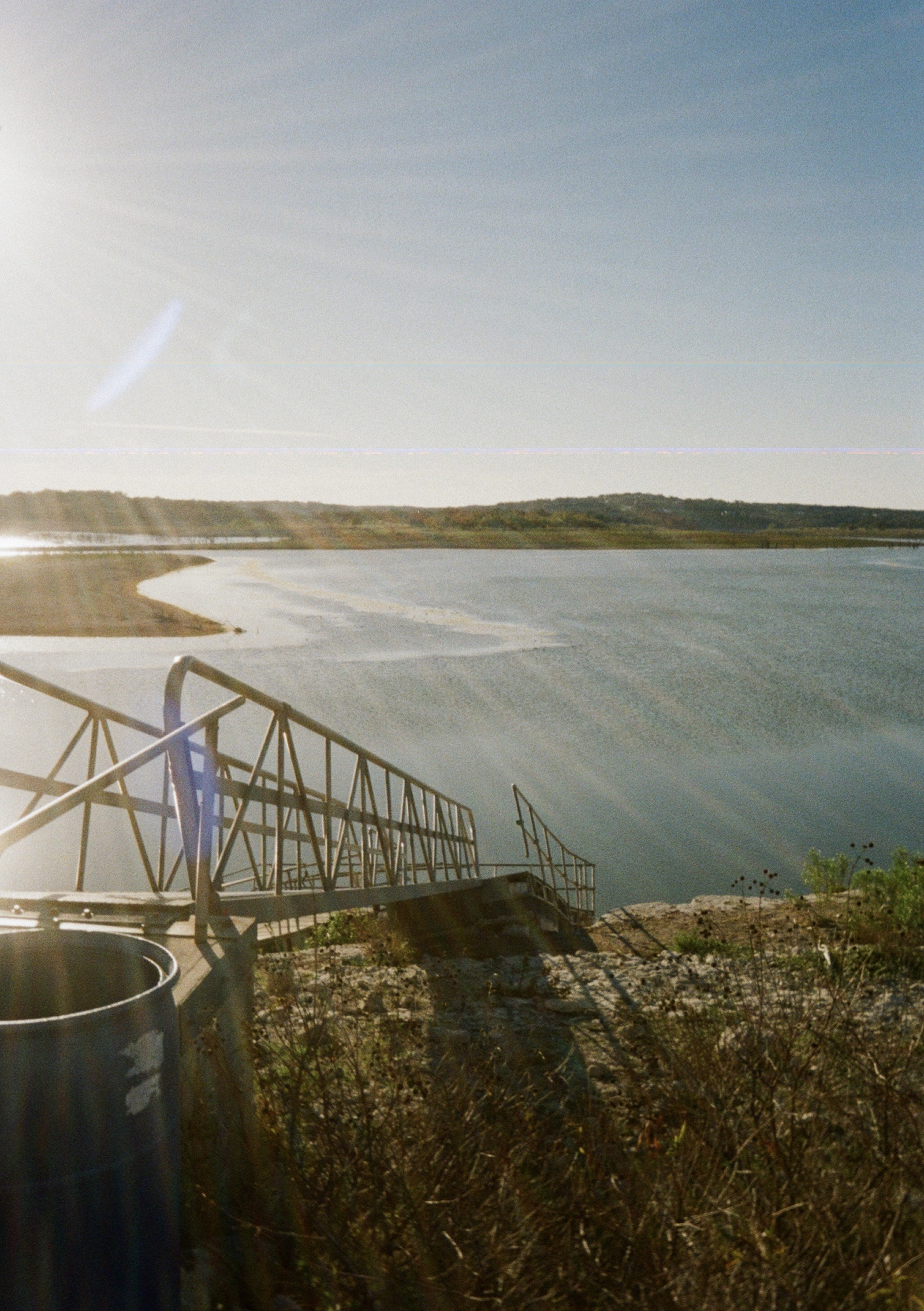 A dock that is atop dry land due to low water levels in the lake