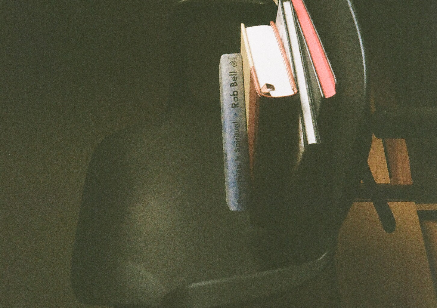 A pile of books on a chair in our living room